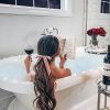 Women-read-a-book-and-drink-wine-in-bathroom