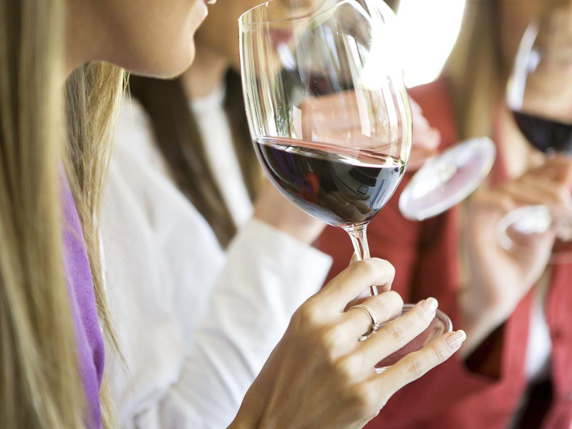 girl tasting red wine