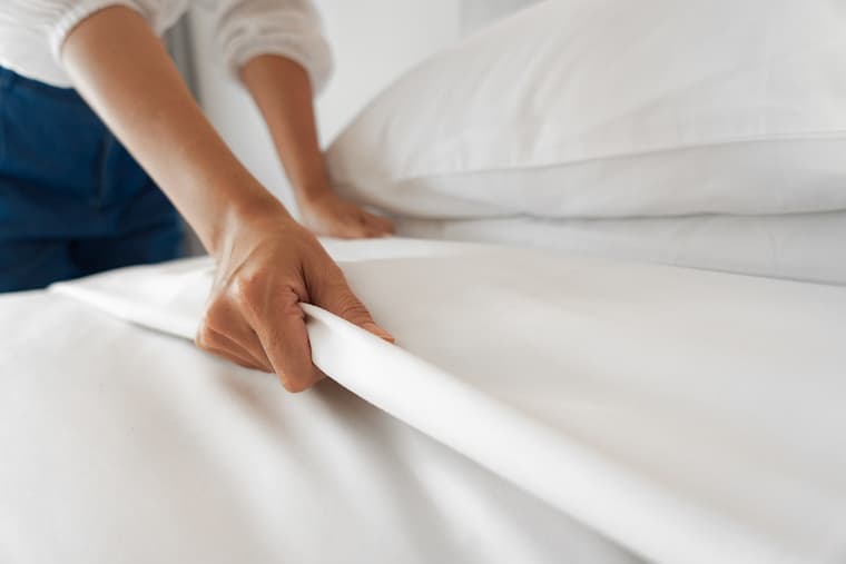 woman's hand on bamboo bedding