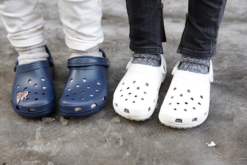 picture of persons wearing clogs with socks on street