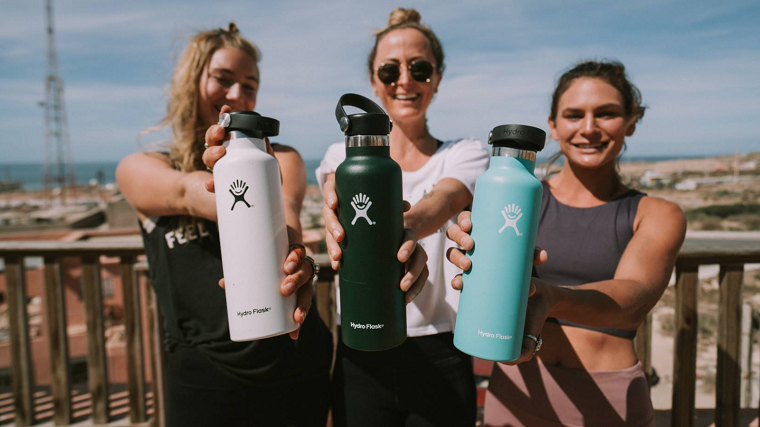women holding hydro flask water bottles 