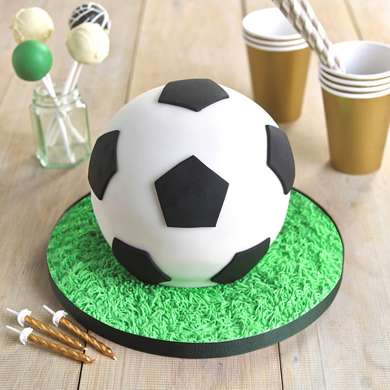 soccer themed sports cake on wooden table 
