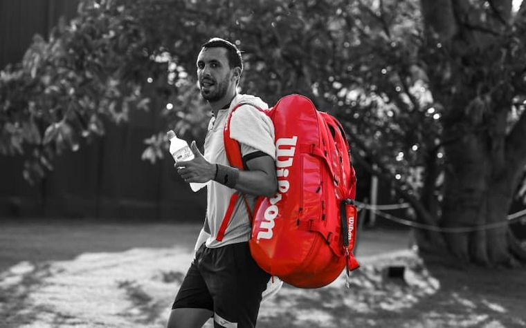 Tennis player with tennis bag 