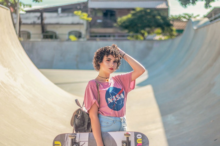 picture of a girl in a skatepark holding a skateboarder 