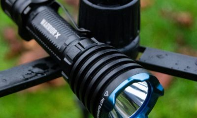 picture of an Olight flashlight on a fence