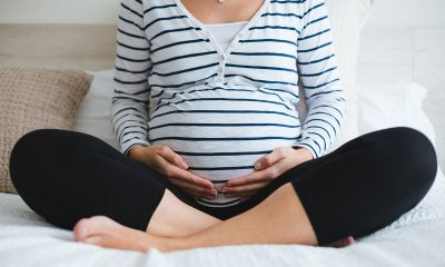 picture of a pregnant woman sitting on a bed