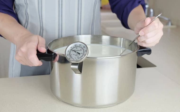 large pot at thermometer for home cheese-making
