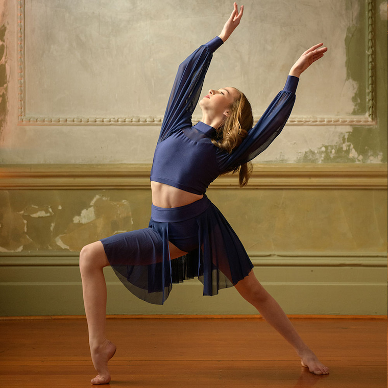 girl poses with dance costume