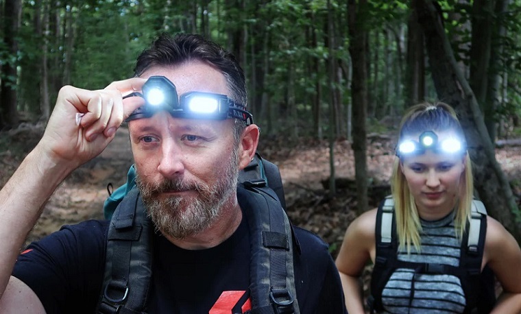 man and woman using headlamps