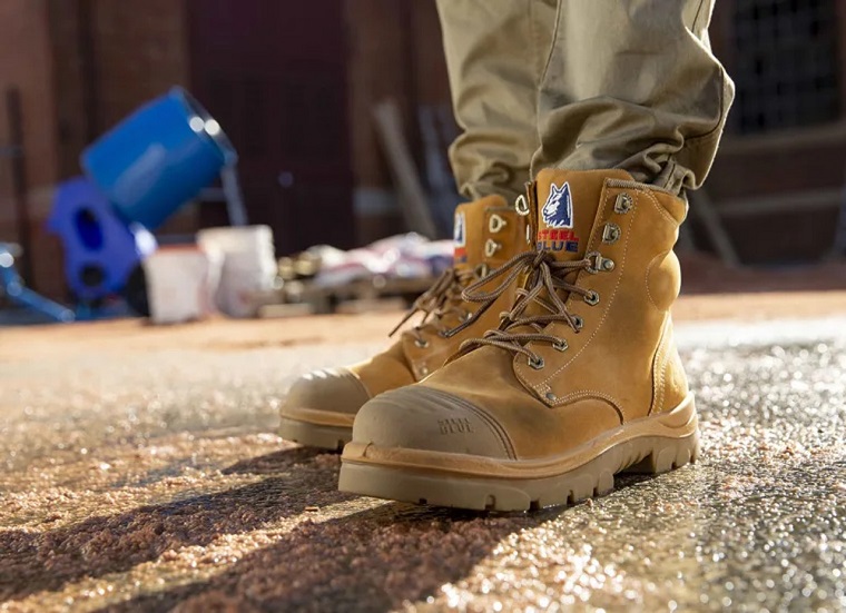 close-up of a builder in work clothes and boots