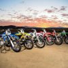 Five dirt bikes on stands on mountain