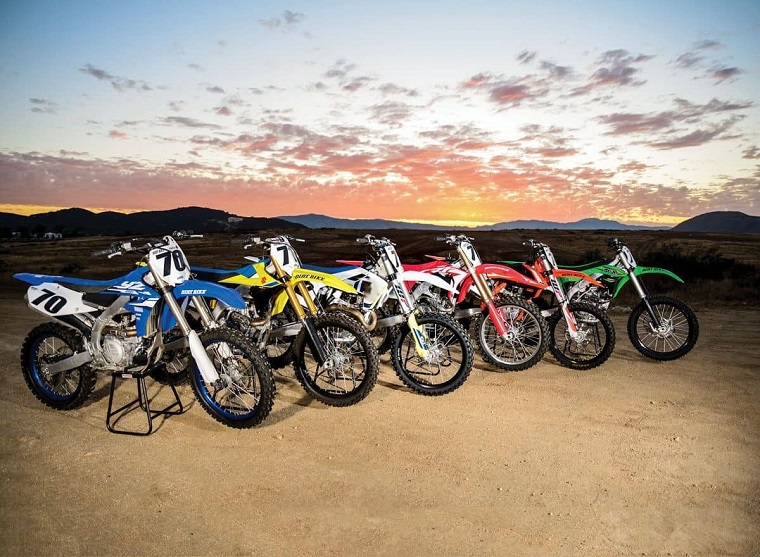 Five dirt bikes on stands on mountain
