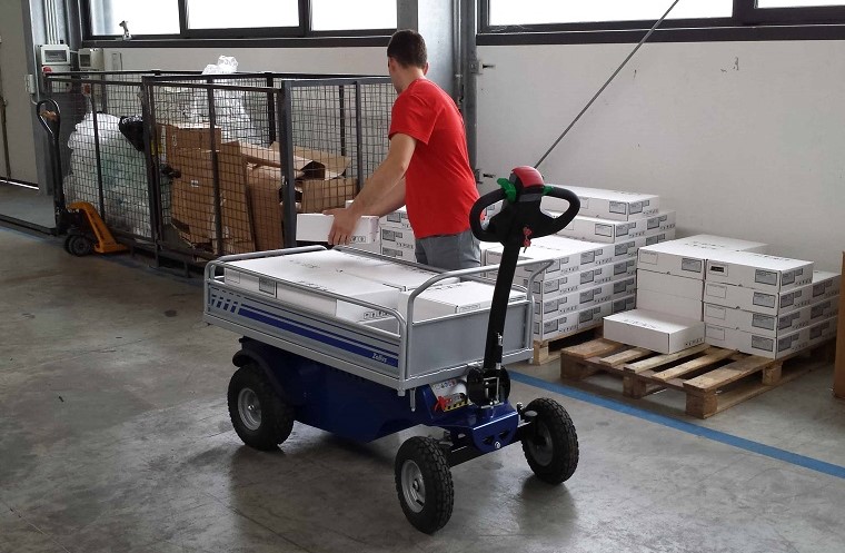 Electric platform trolley with load in a warehouse