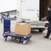Electric platform trolley with load by the van and woker