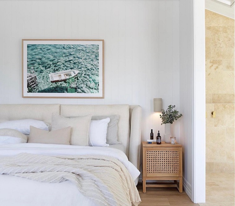 bedroom with coastal artwork on the wall