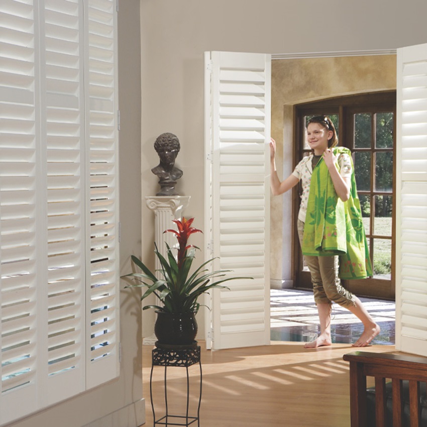 girl standinng and looking at the shutters 