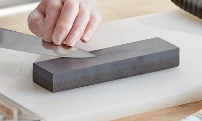 person sharpening a knife on a sharpening knife stone