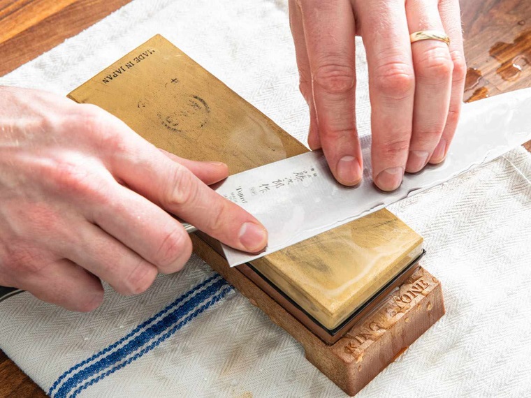 person sharpening a knife